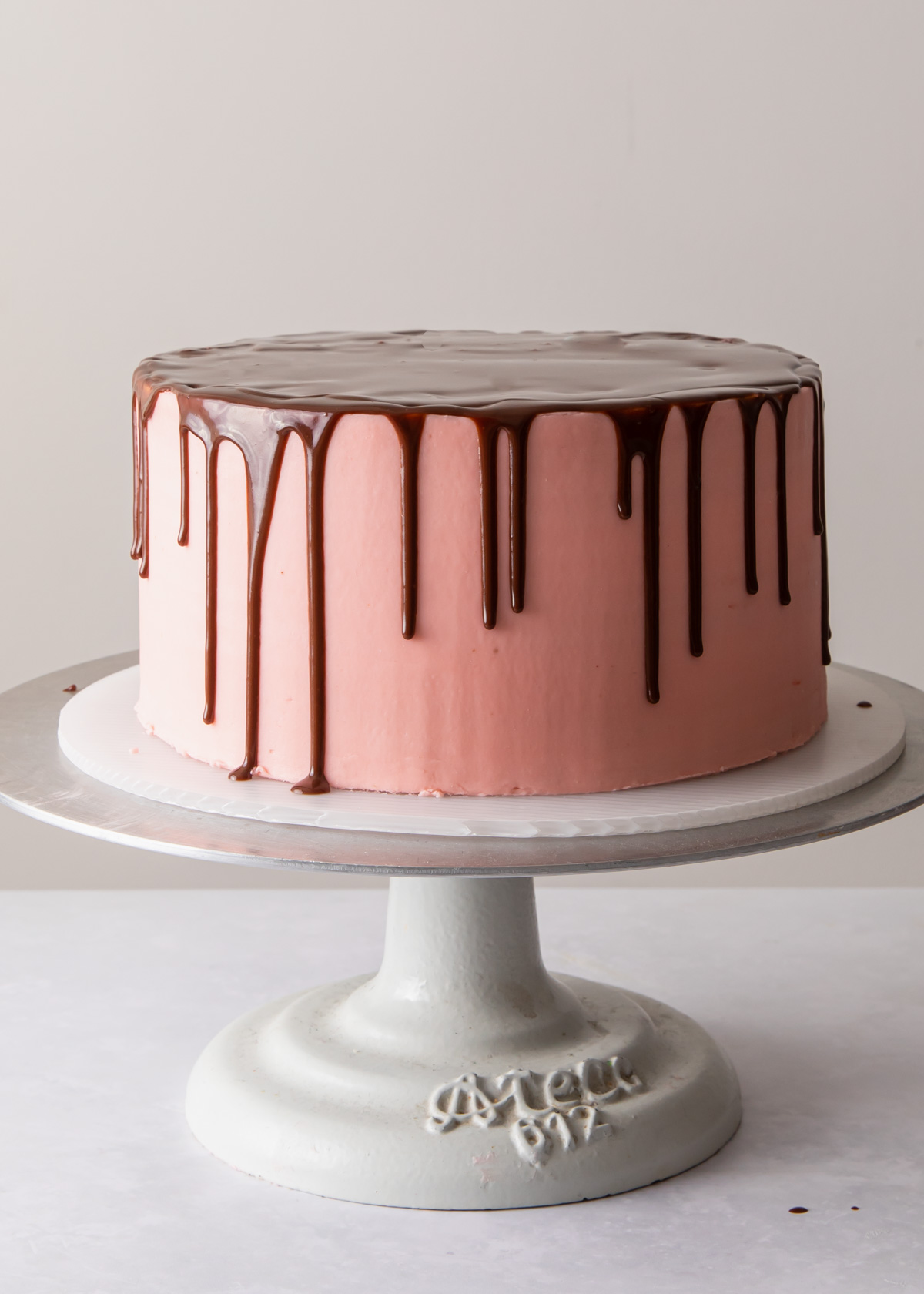 A perfect chocolate drip cake with pink buttercream frosting