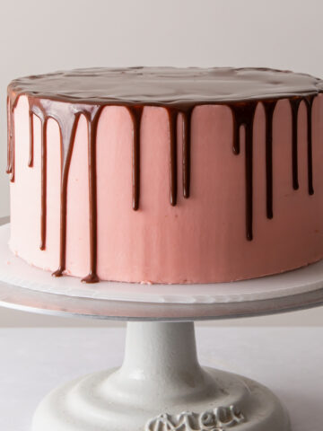 a perfect chocolate drip cake with pink buttercream frosting