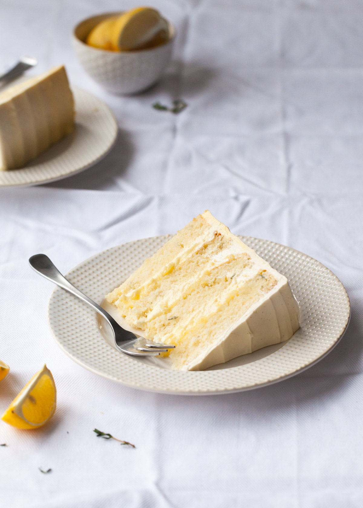 A slice of lemon thyme cake with lemon curd buttercream filling