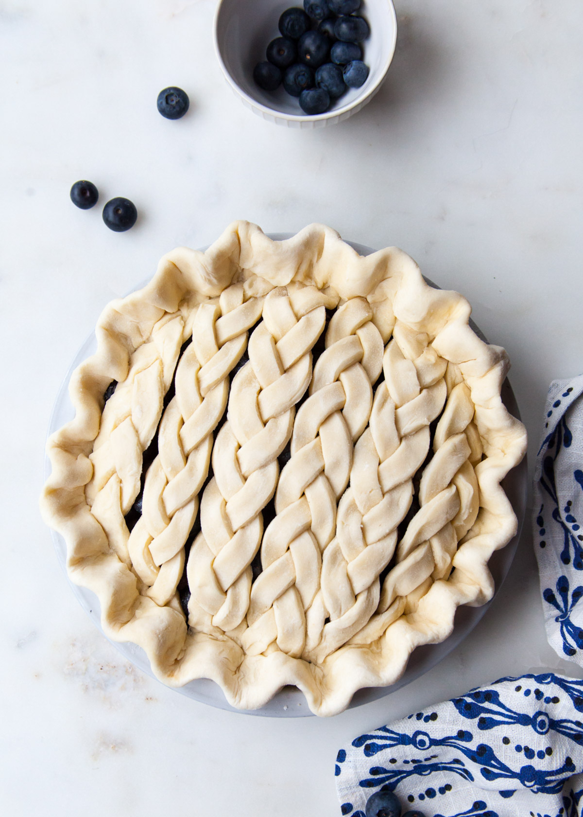 A blueberry pie with braided pie dough on top