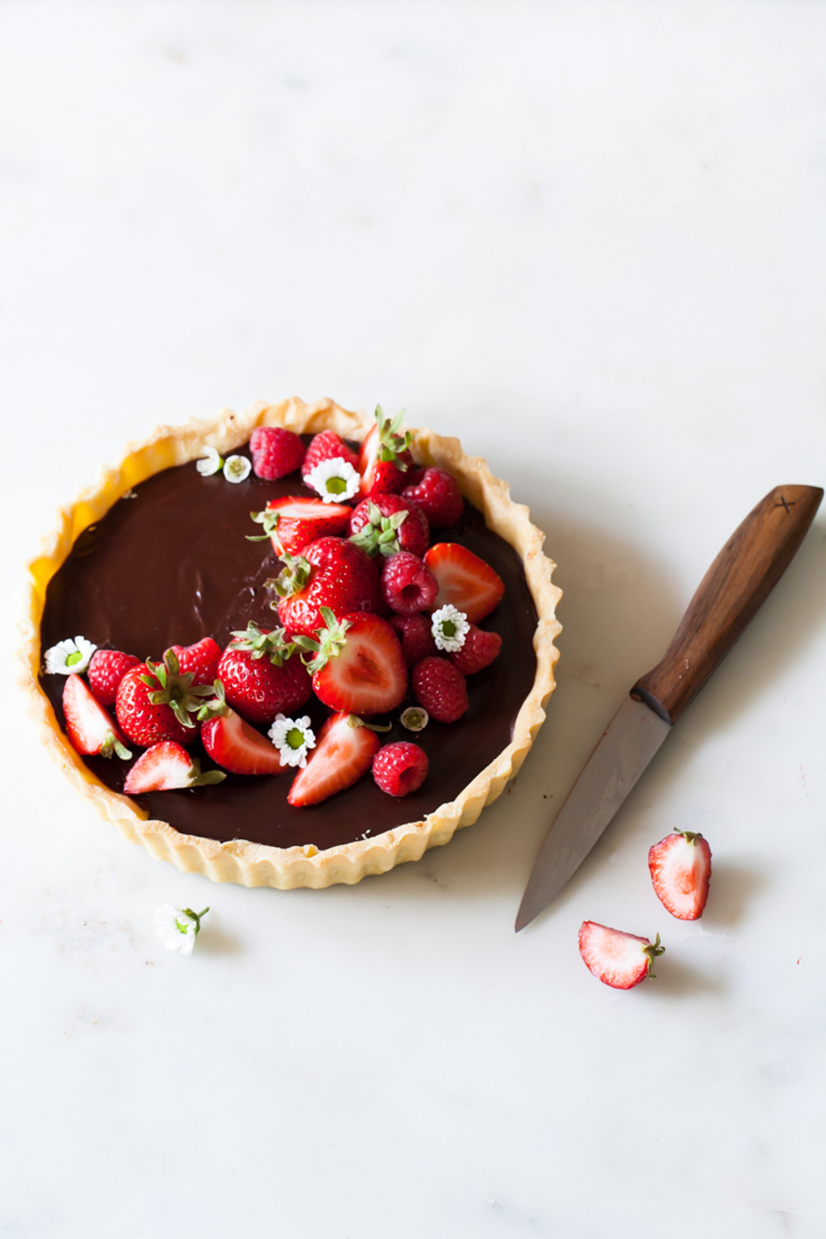 A classic chocolate tart with fresh strawberries and raspberries on top