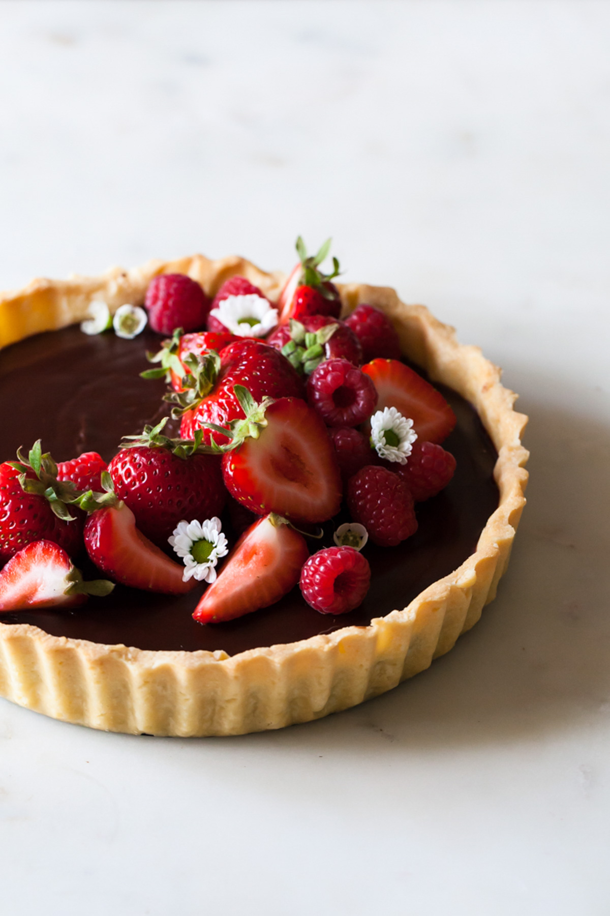 A Chocolate Ganache Tart with fresh raspberries and strawberries on top