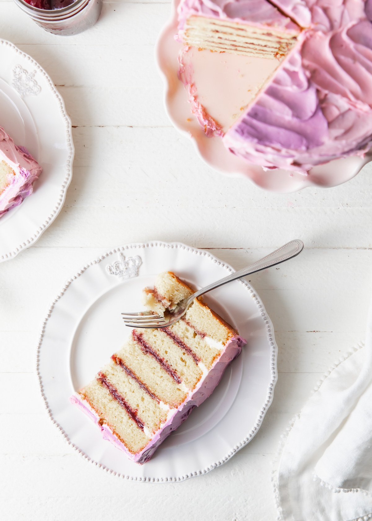 A slice of cake with blackberry jam filling.