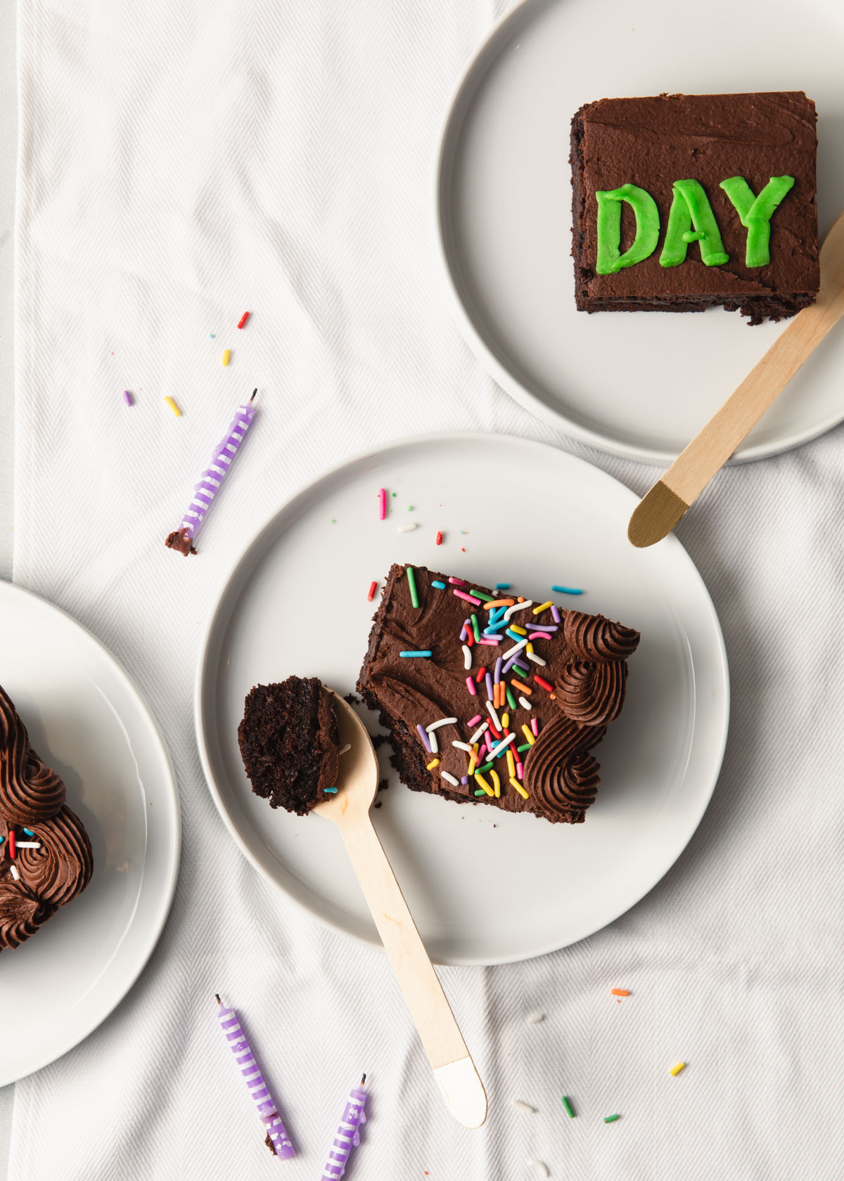 An overhead image of slices of chocolate sheet cake with fudge frosting