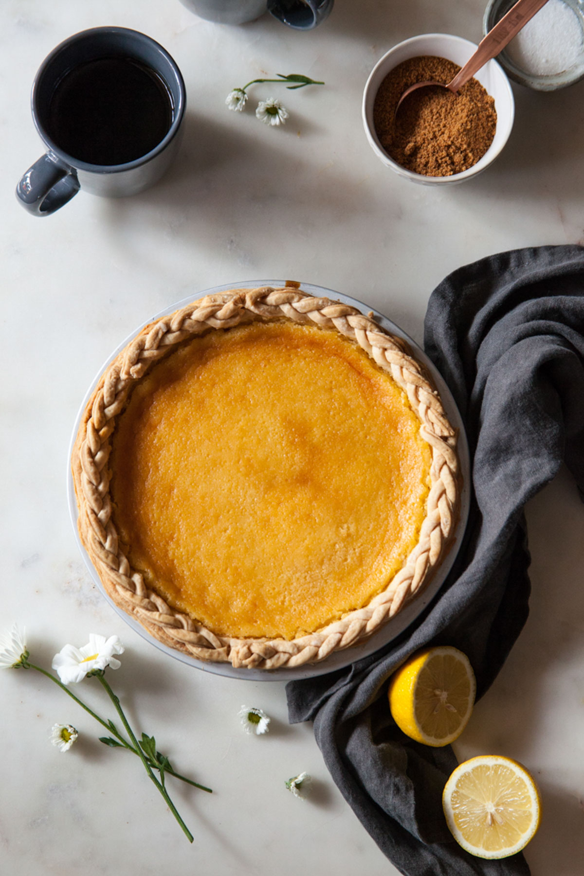 A baked lemon chess pie with a braided pie crust