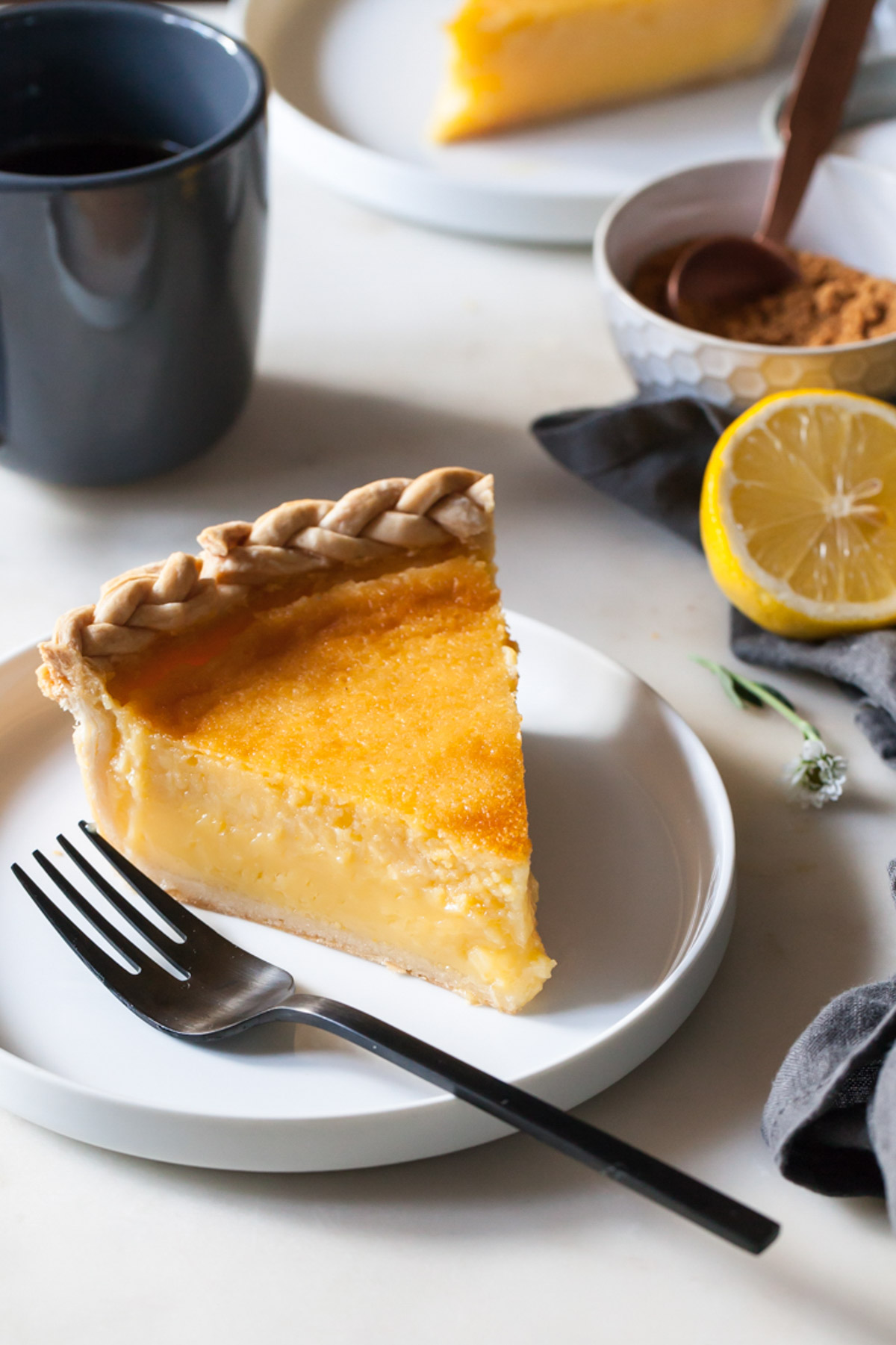 A think slice of lemon chess pie on a plate