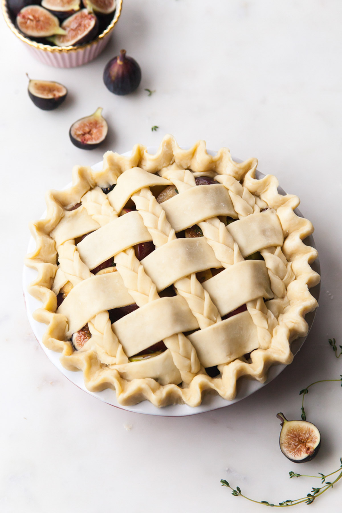 A fig plum pie with thyme and a braided lattice top