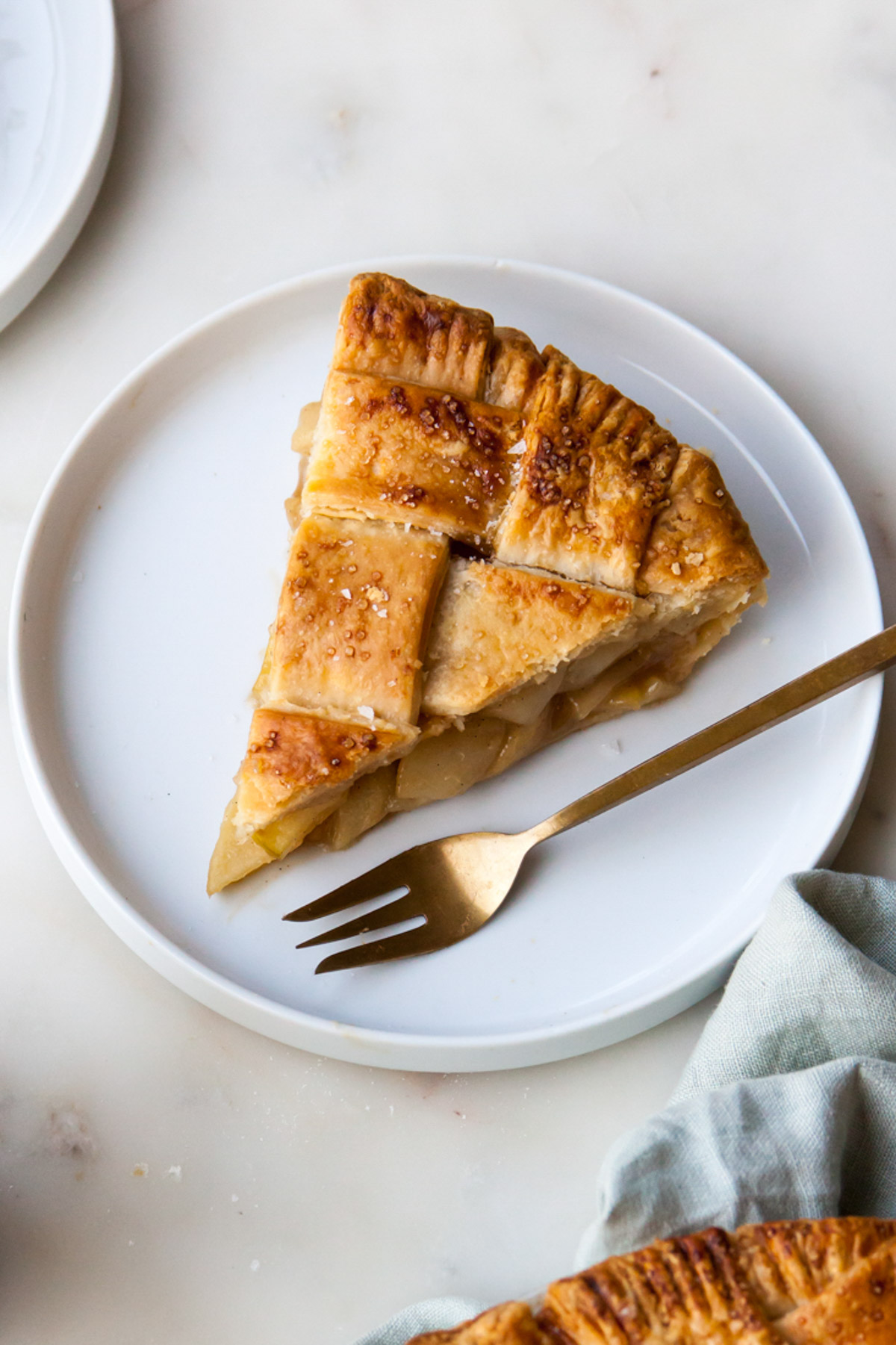 A slice of pear pie with butterscotch and a lattice top