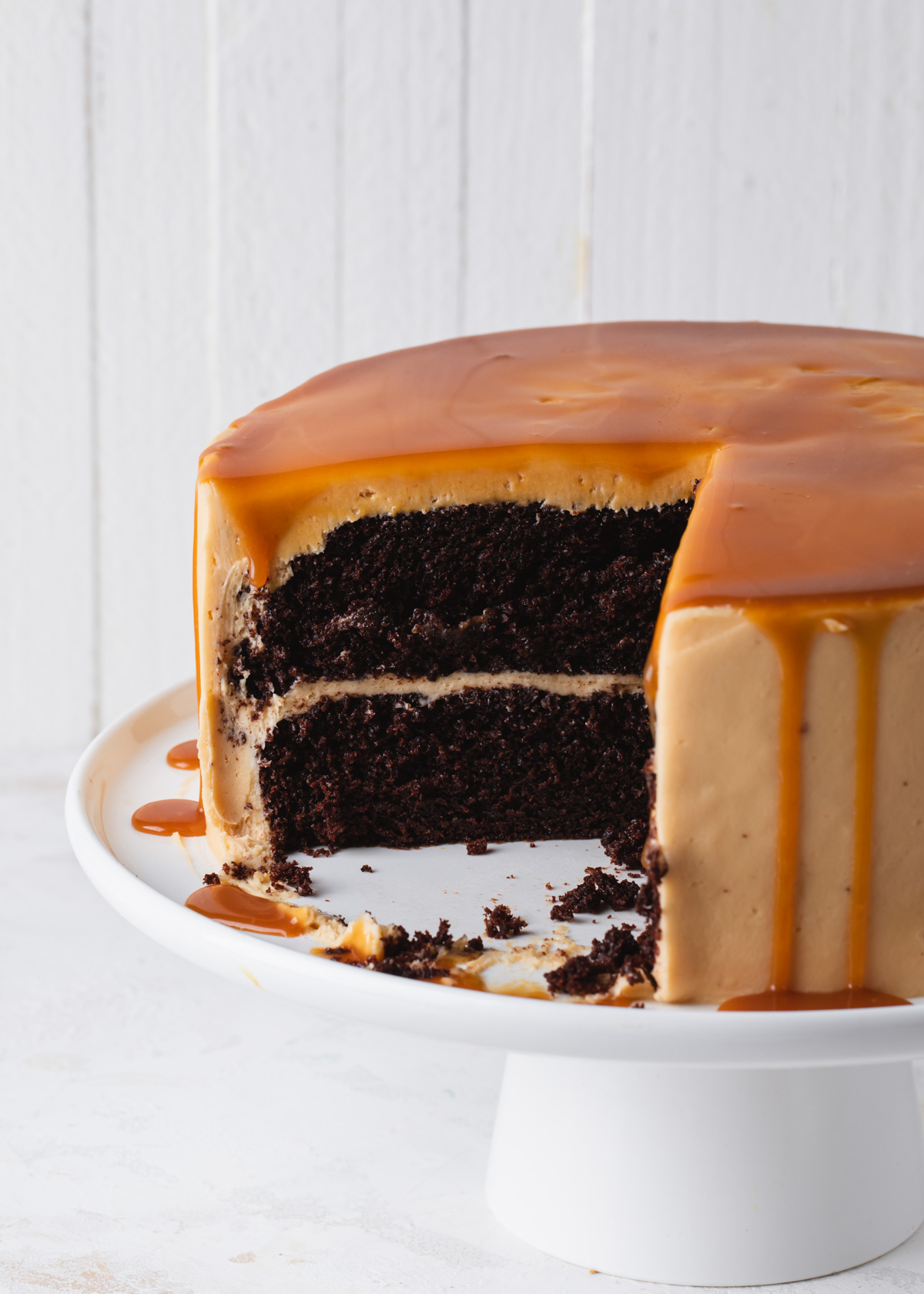 A close up of a chocolate caramel cake that's been sliced