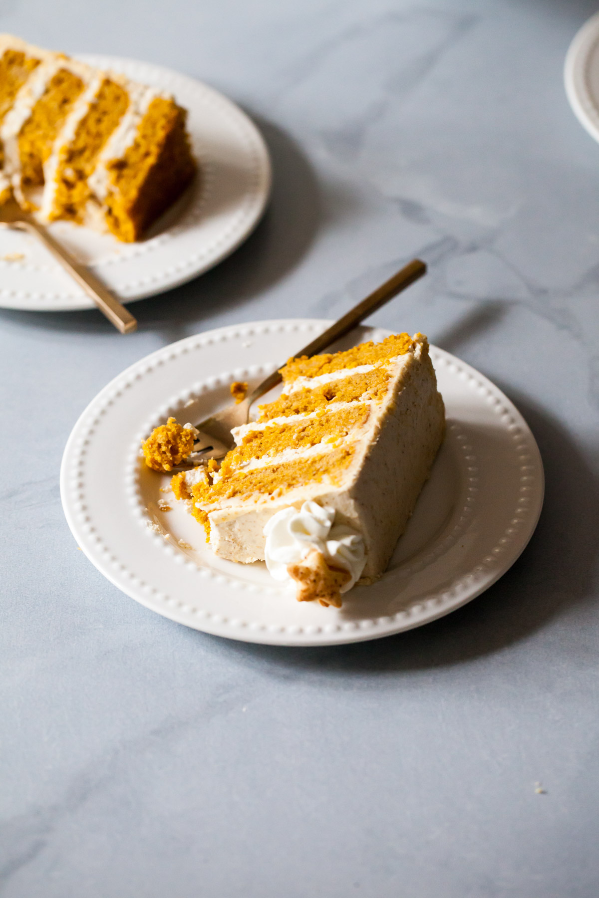 A slice of pumpkin layer cake with graham cracker buttercream
