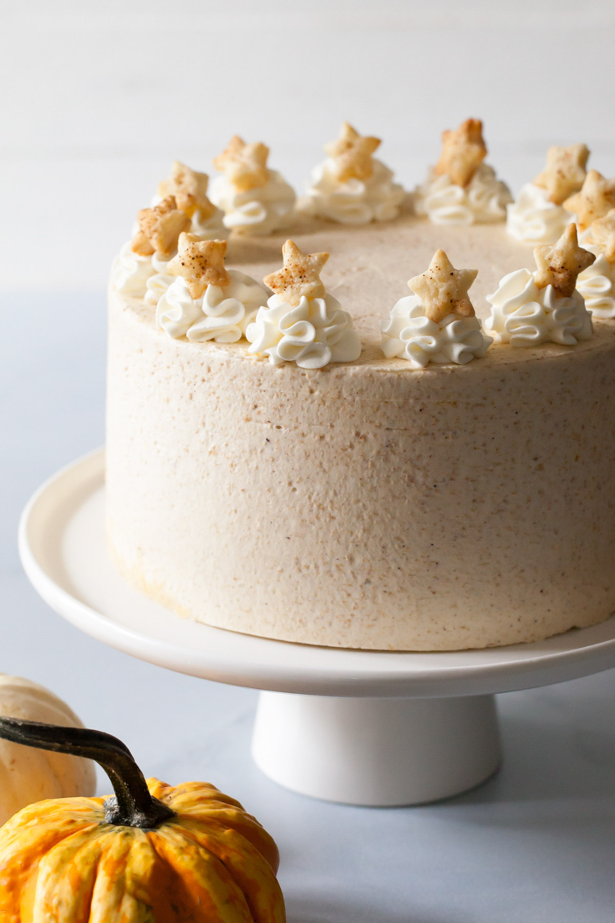 Pumpkin pie cake with dollops of whipped cream and pie crust stars