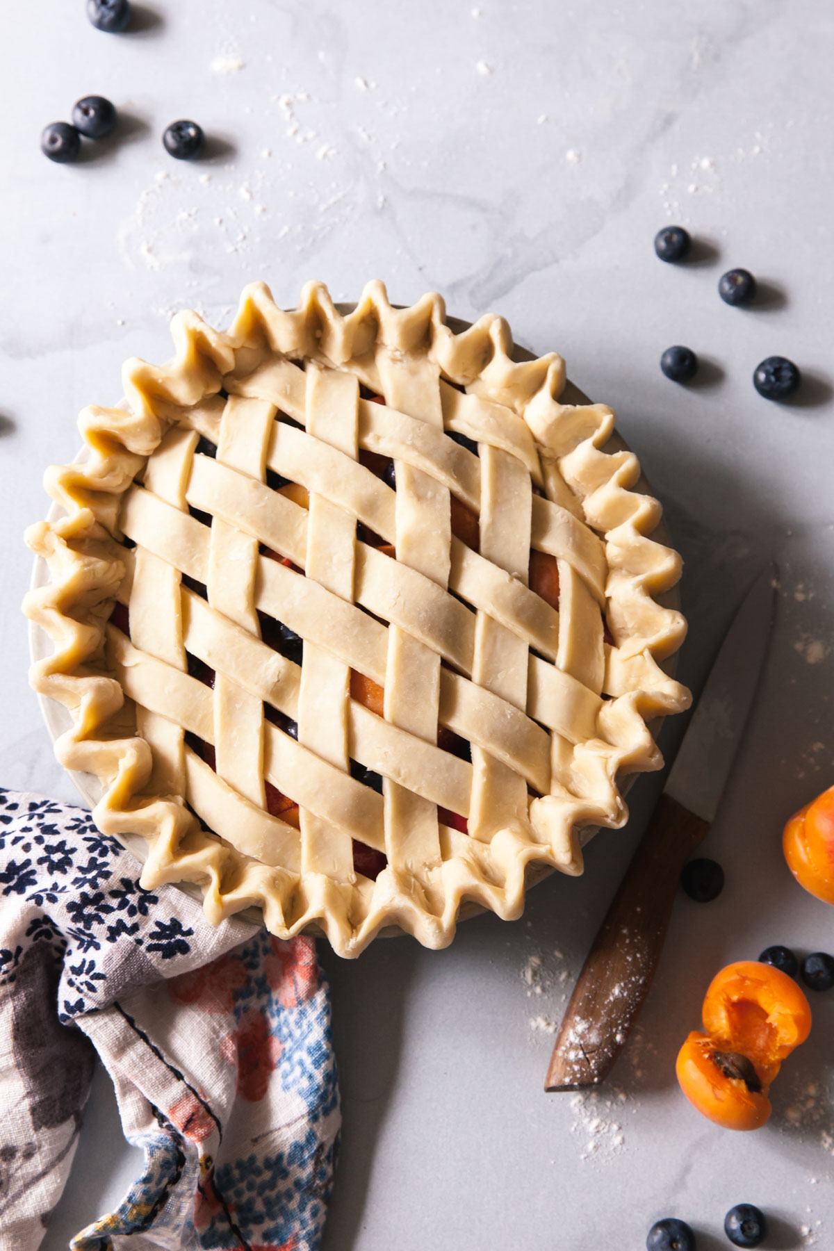 A blueberry peach pie with a lattice crust before baking
