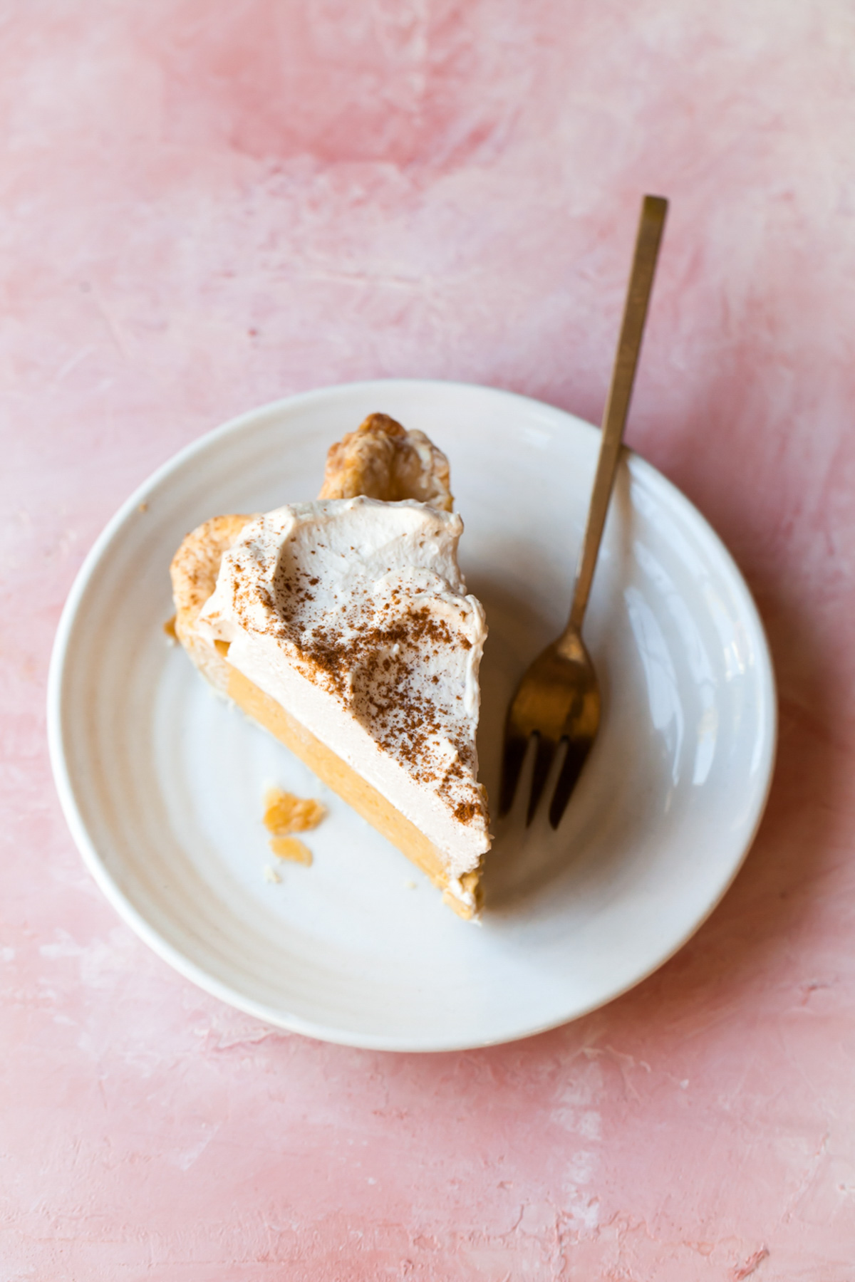 A slice of pumpkin chiffon pie with whipped cream on top