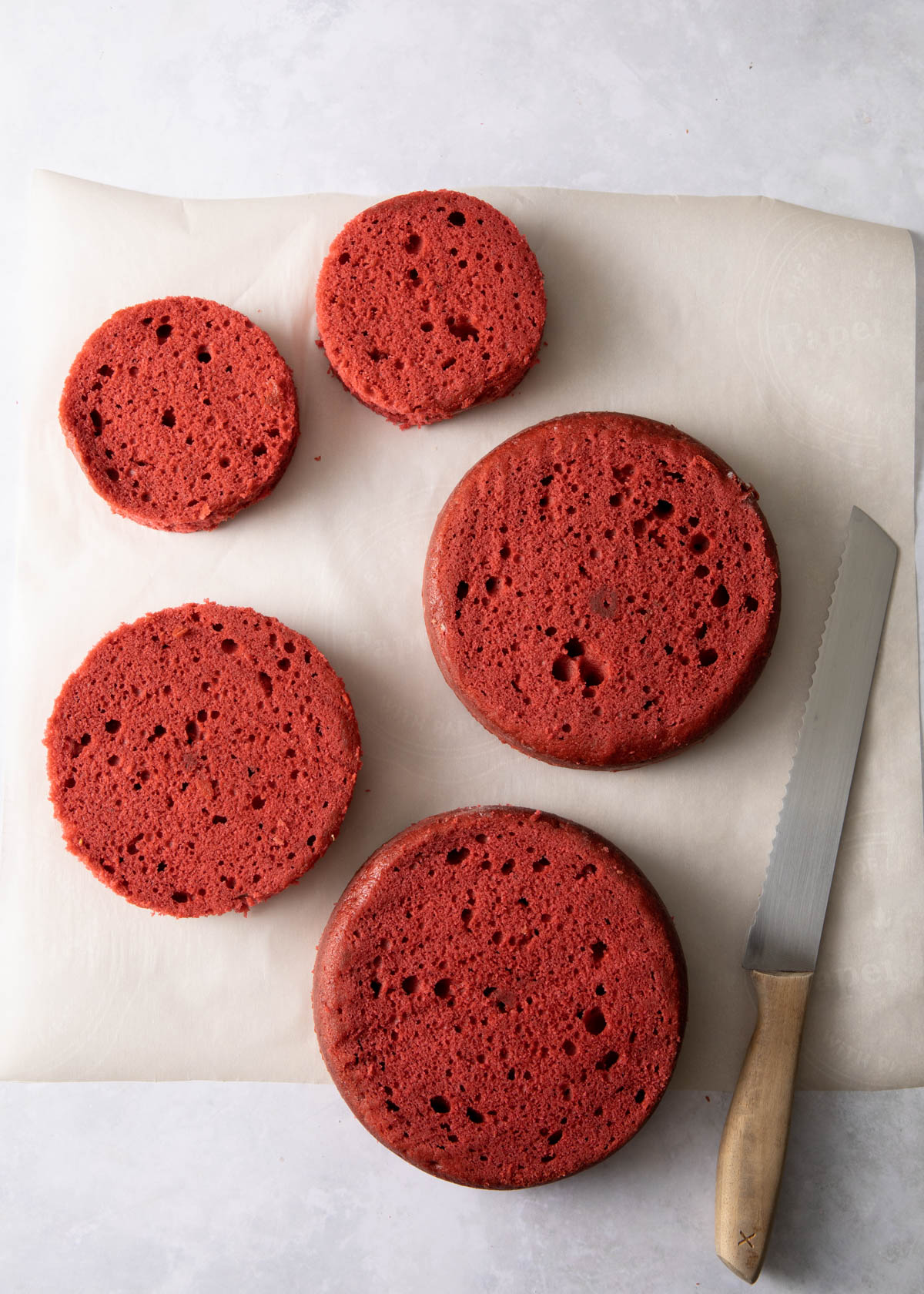 Red velvet cake that has been trimmed for creating a Christmas tree cake
