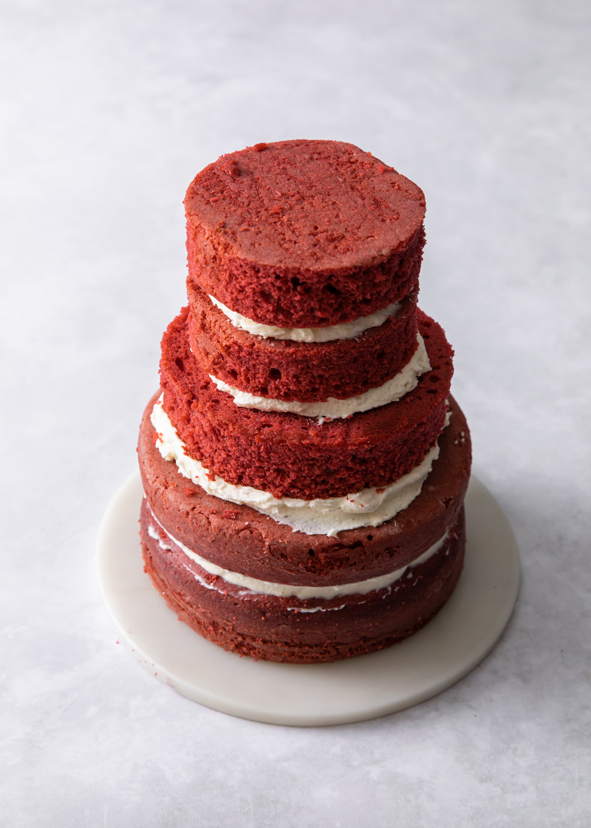 Stacking red velvet cake layers to form a tree