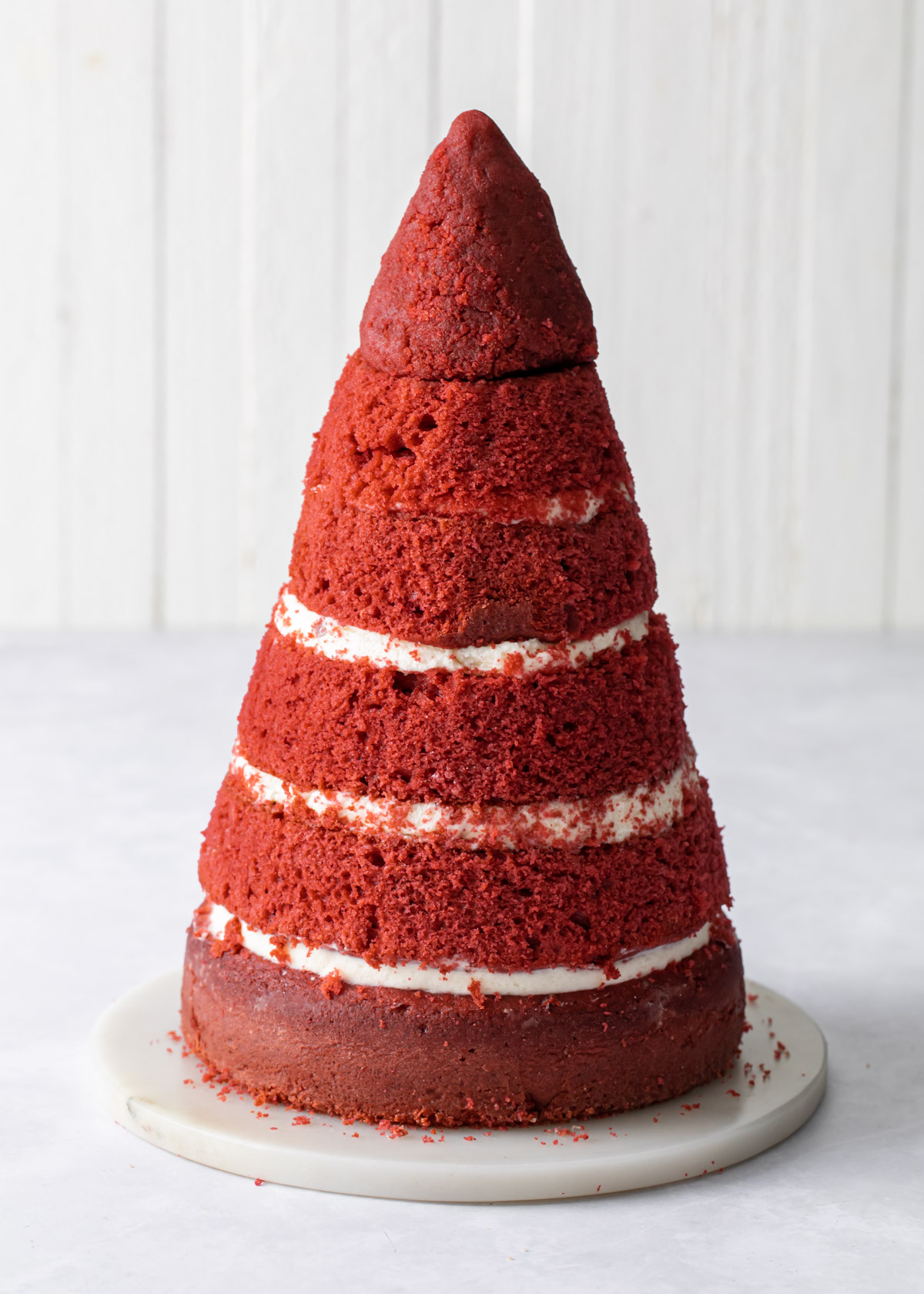Carved cake layers to form the shape of a Christmas tree