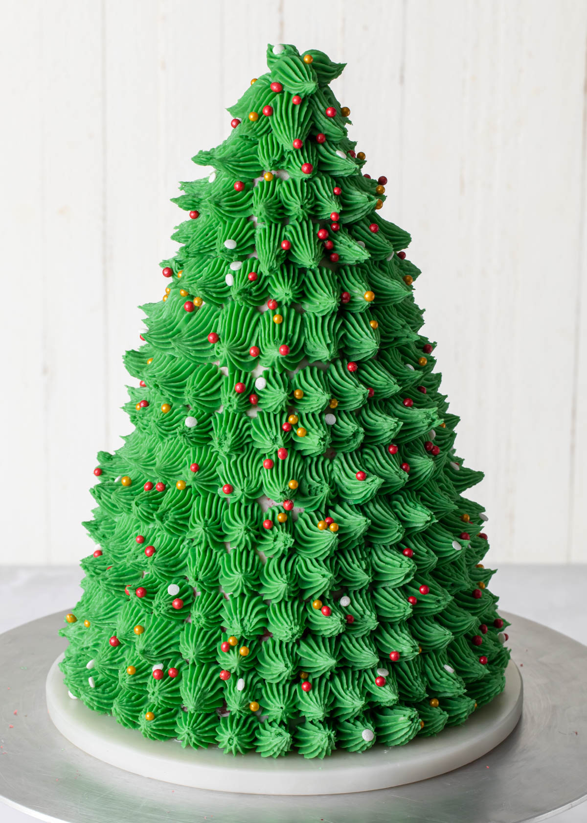 a close-up of buttercream piped Christmas tree cake