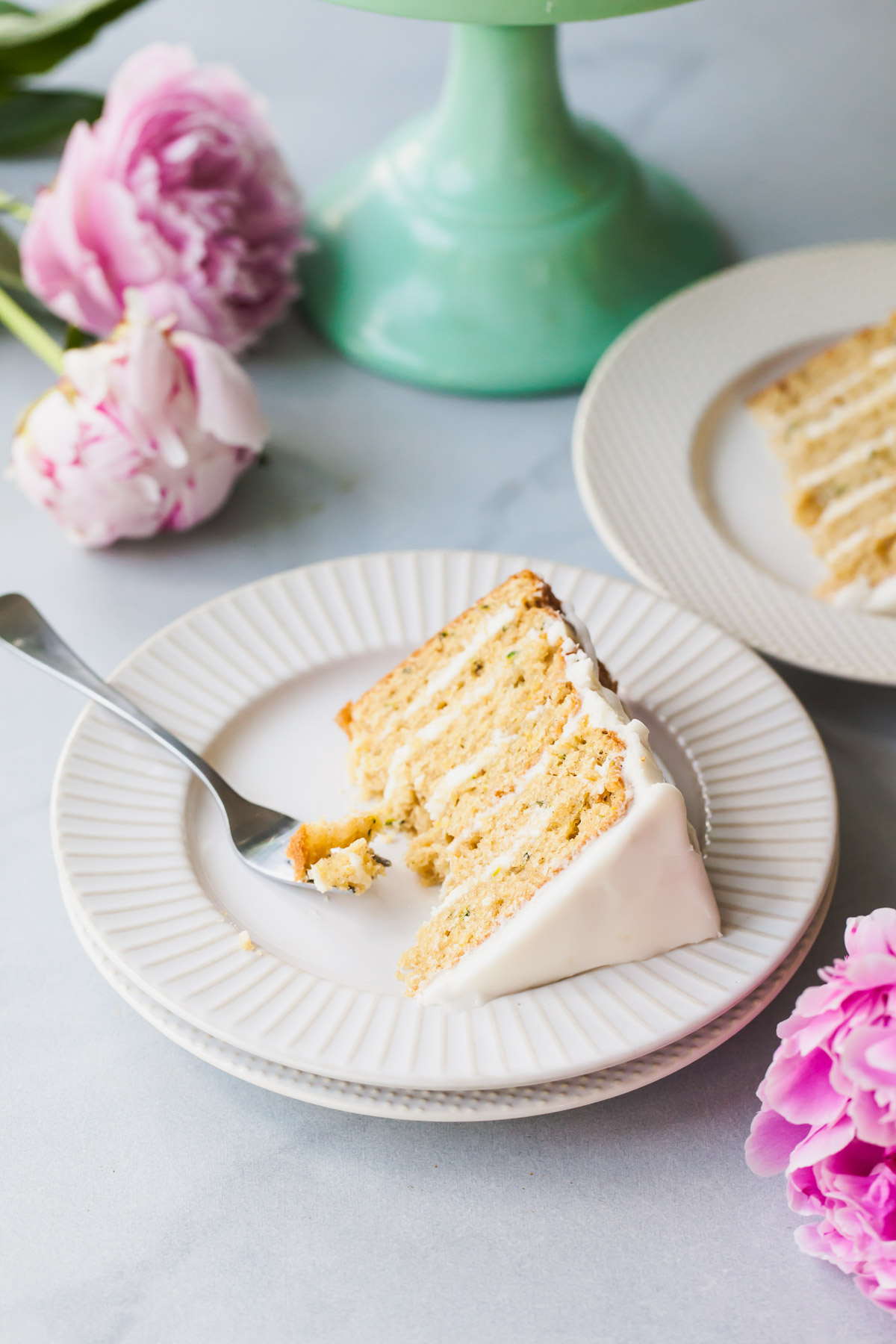 slices of lemon zucchini cake with goat cheese frosting