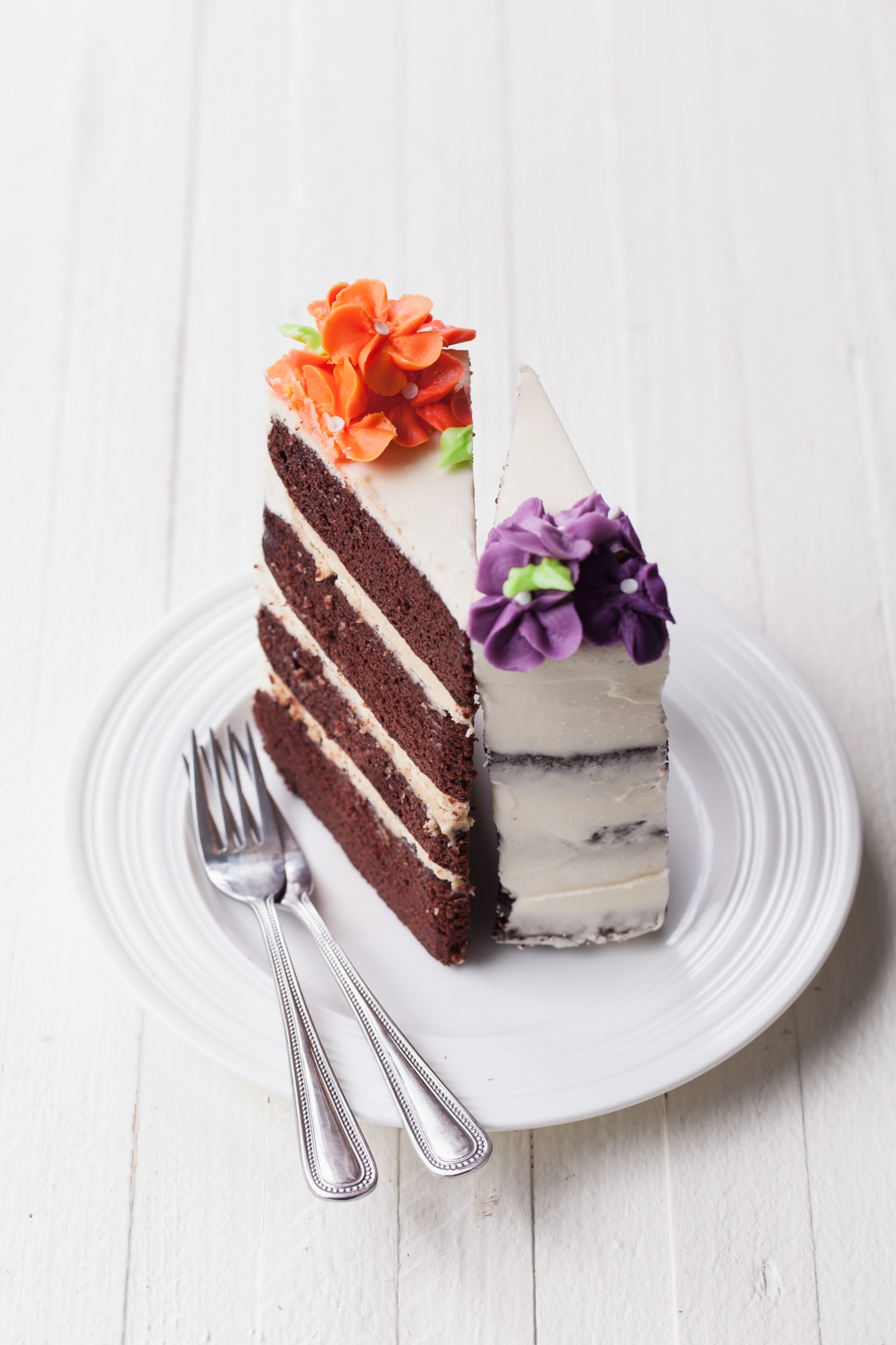 Slices of chocolate cake with buttercream flowers on top