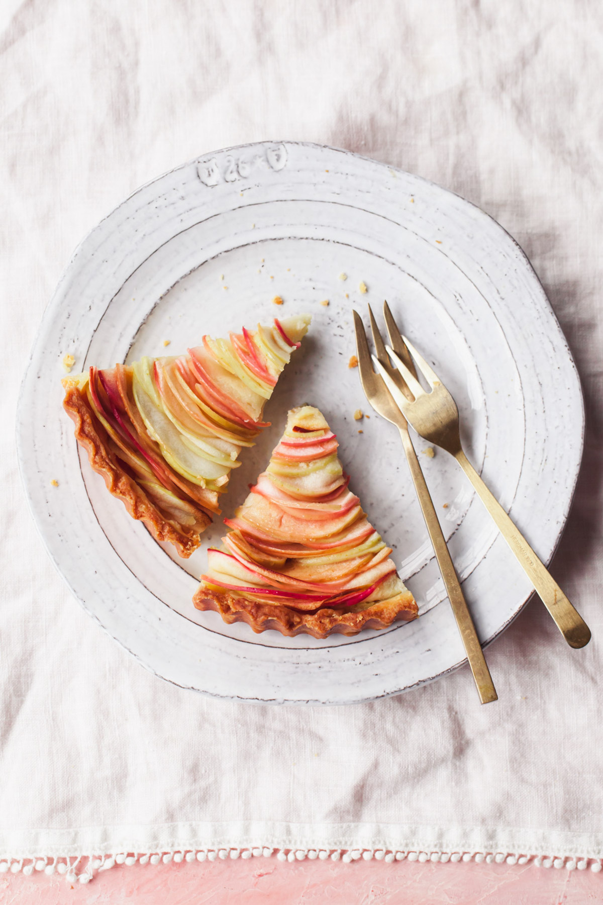 Two sliced of apple tart on a plate