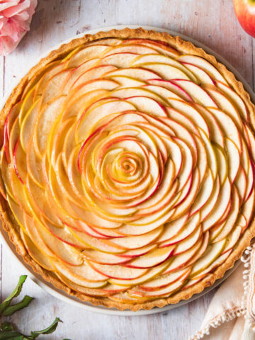 A baked apple rose tart with almond filling