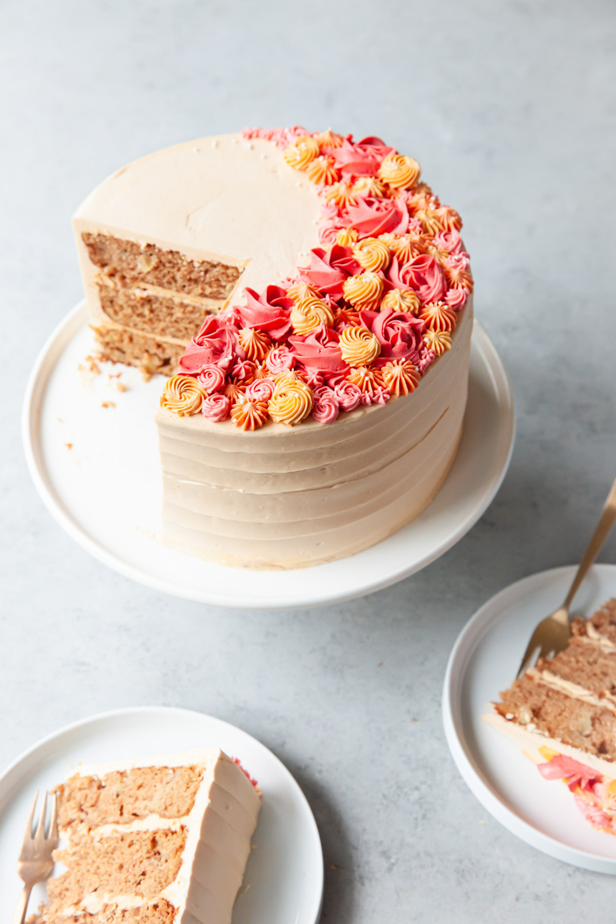 A caramel apple spice cake decorated with dulce de leche buttercream.