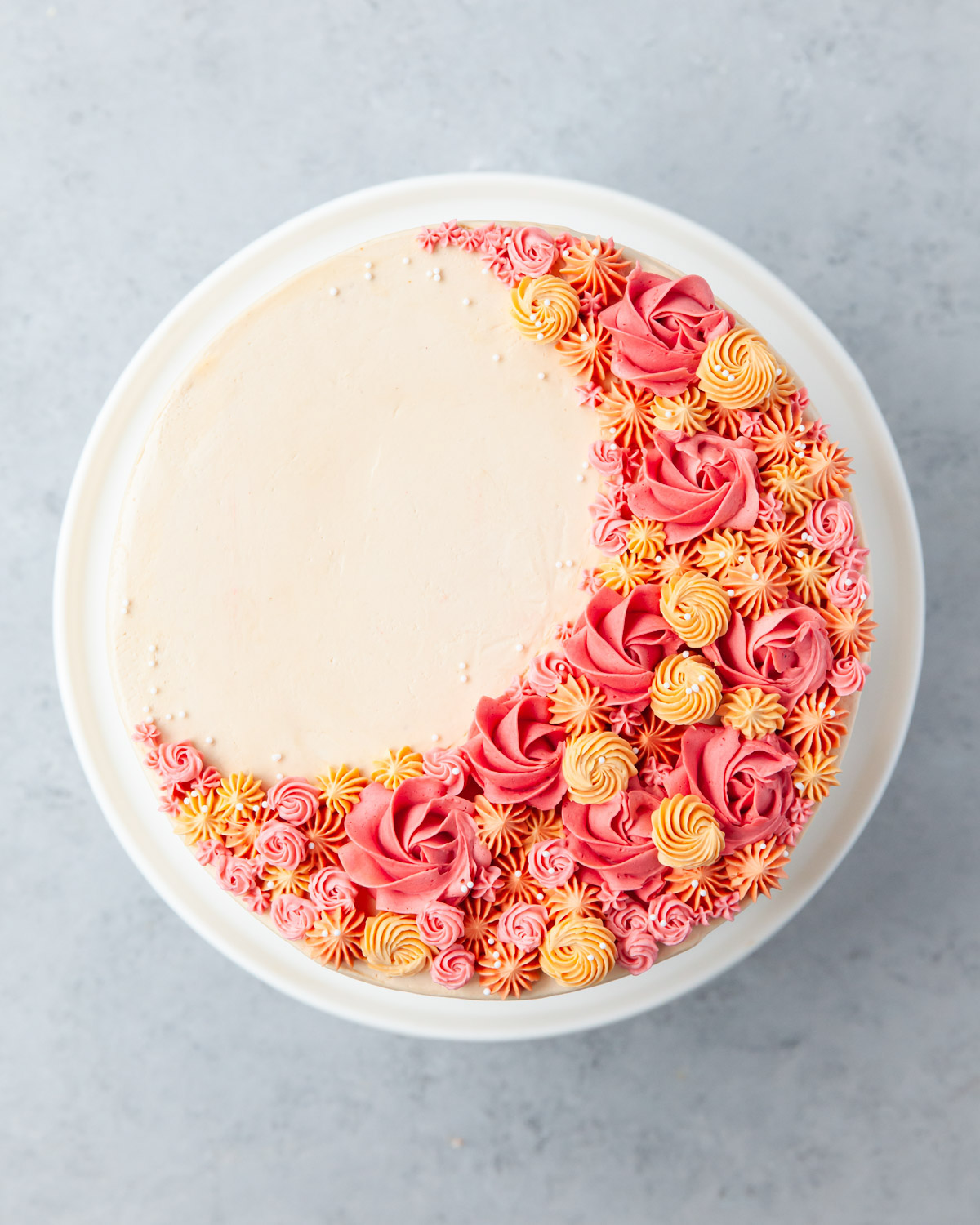 Buttercream rosettes piped on top of an apple spice cake.