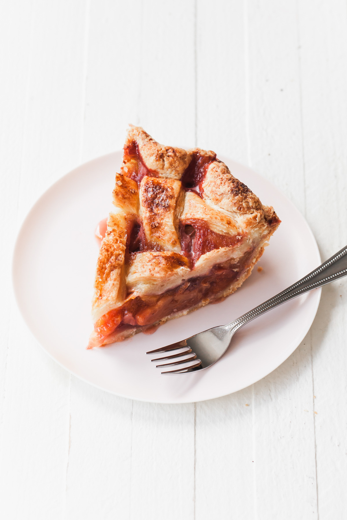 A slice of peach strawberry pie