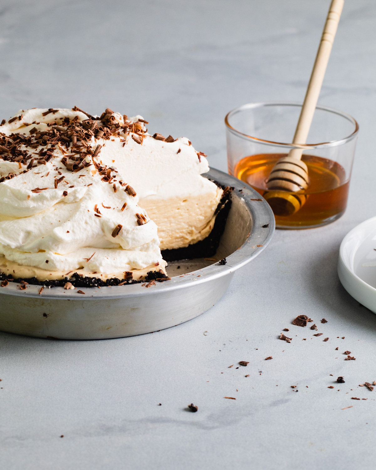 A no-bake peanut butter pie with whipped cream that's been sliced in its pie pan