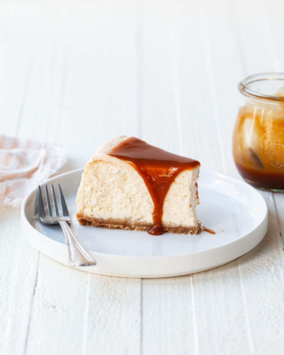 A slice of cheesecake with caramel sauce on top