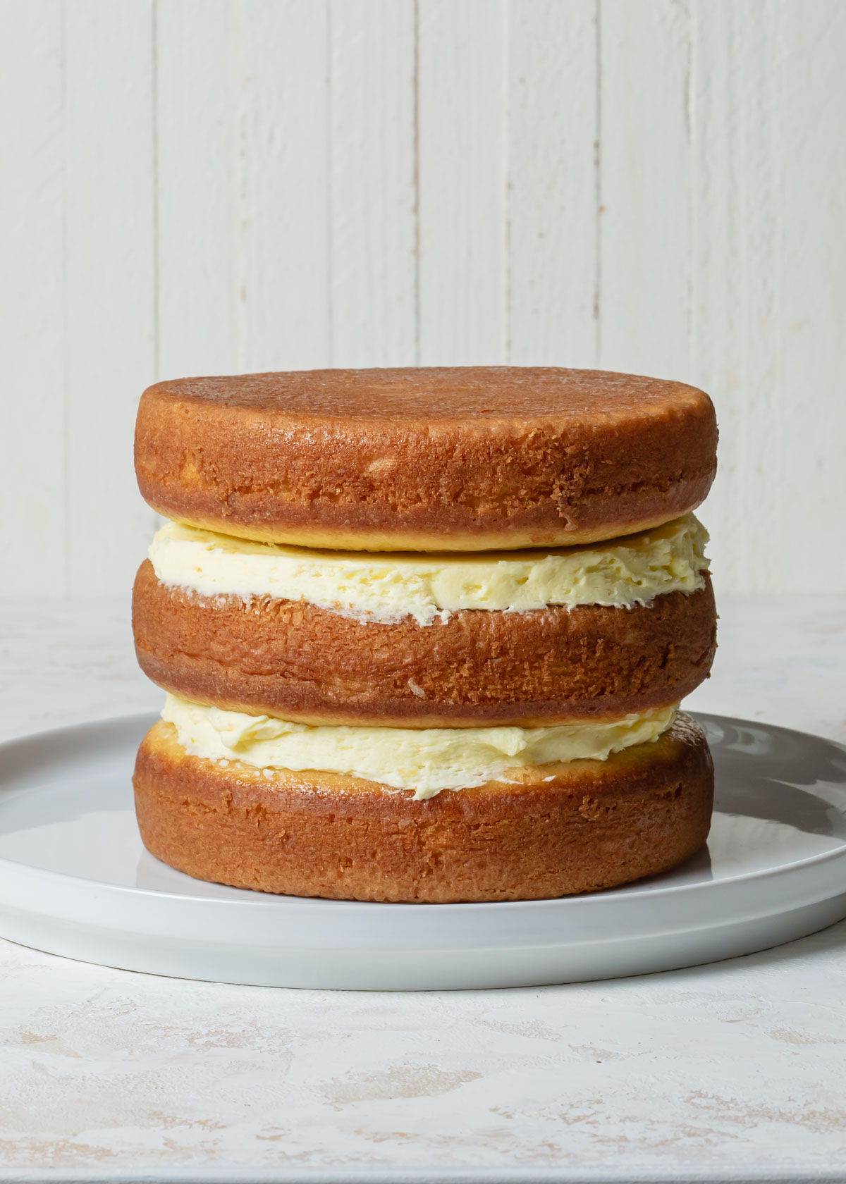 A three layer cake stacked with lemon filling 