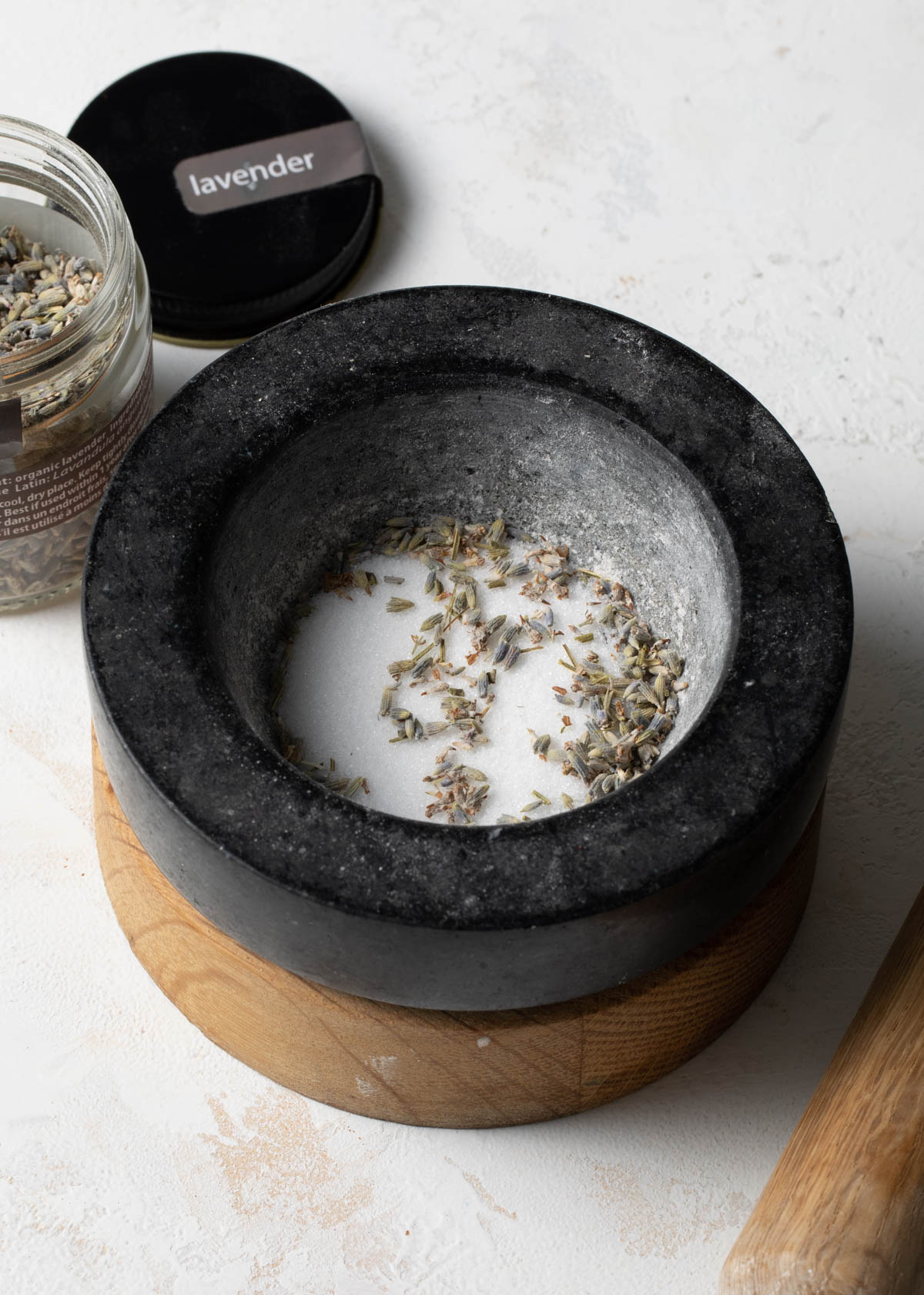 Dried lavender and sugar in a mortar and pestle