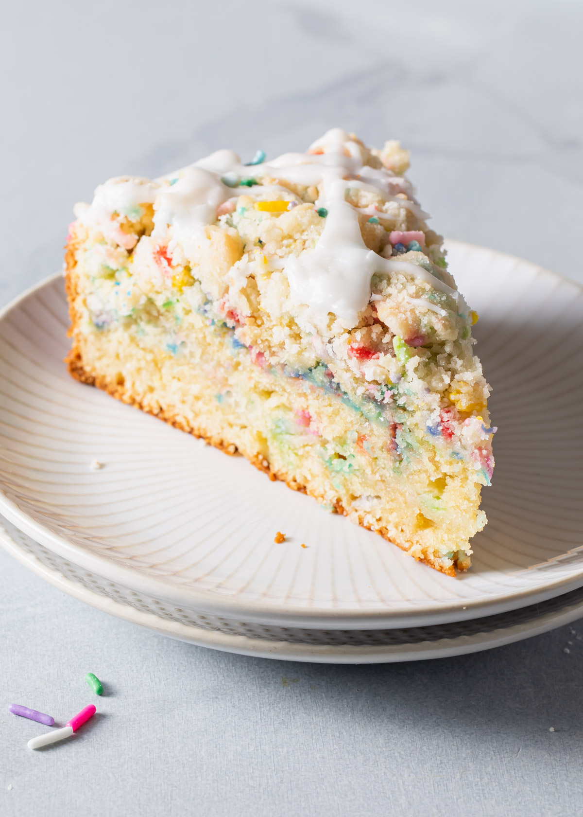 A slice of sprinkle coffee cake on a plate