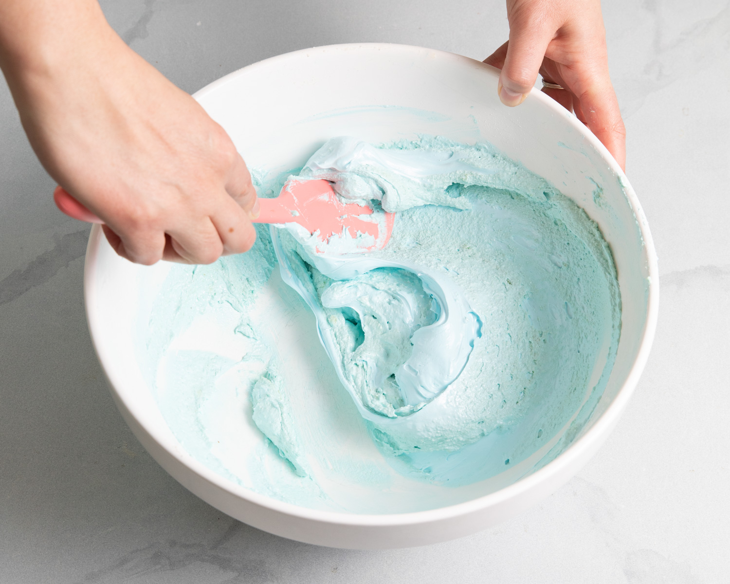 mixing macaron batter