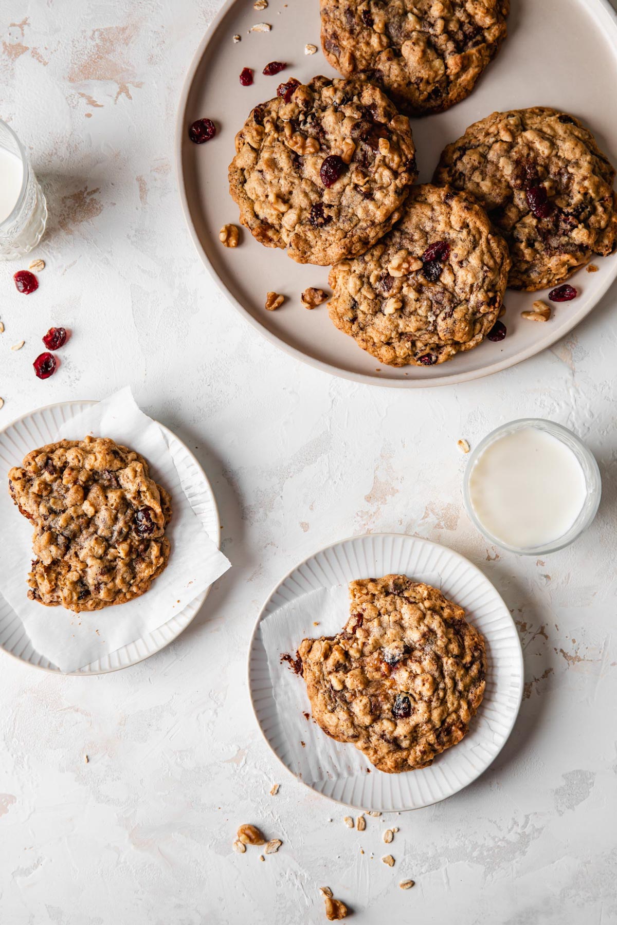 Plates of oatmeal cookies with cranberries, walnuts, and chocolate