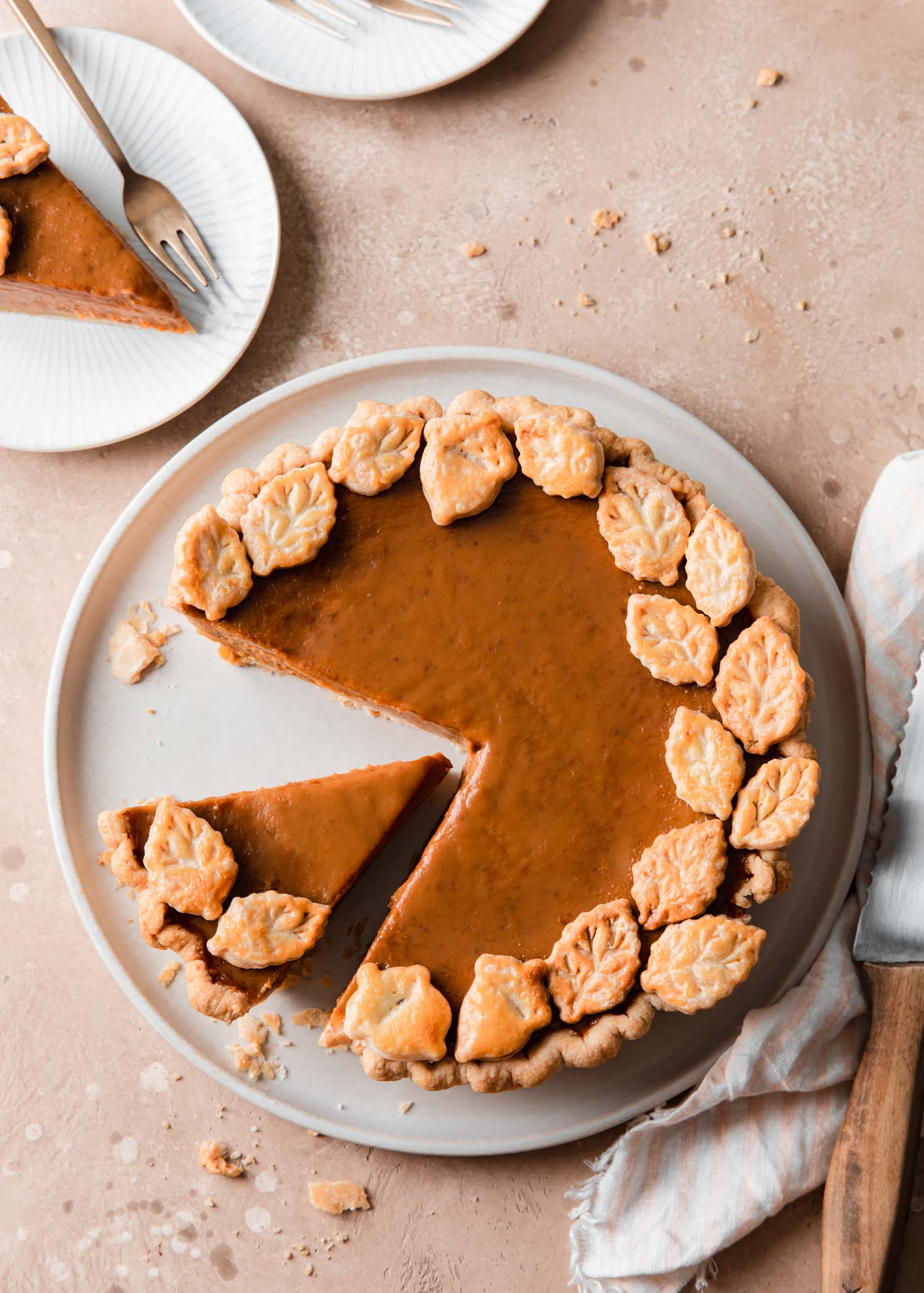 Pumpkin pie with pie dough cut out that decorate around the edge