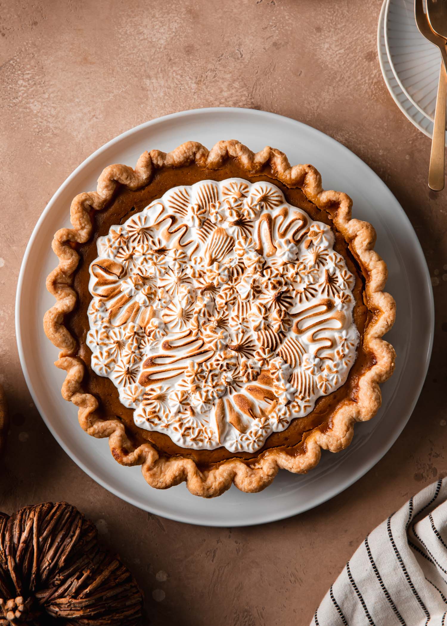 Pumpkin pie decorated with pipe meringue that has been toasted