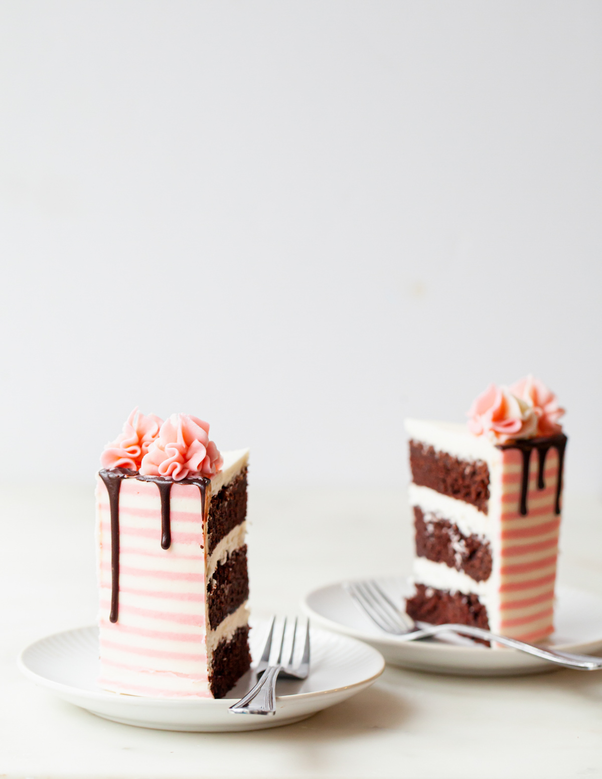 Slices of chocolate peppermint cake with pink and white candy cane stripes