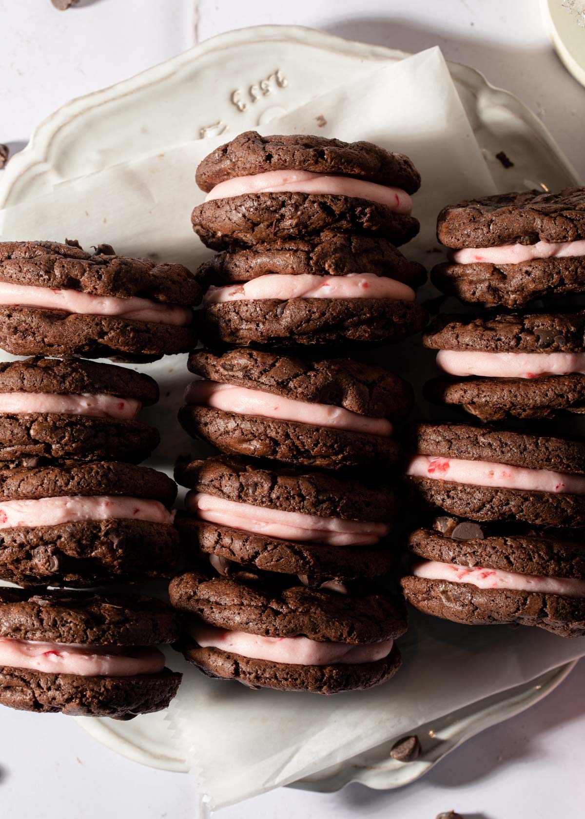 Stacks of chocolate peppermint cookies with pink buttercream filling