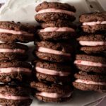 Stacks of chocolate cookies filled with pink peppermint buttercream