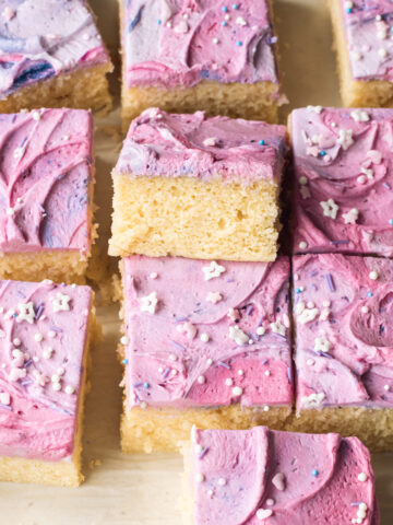 Squares of sliced vanilla sheet cake with buttercream