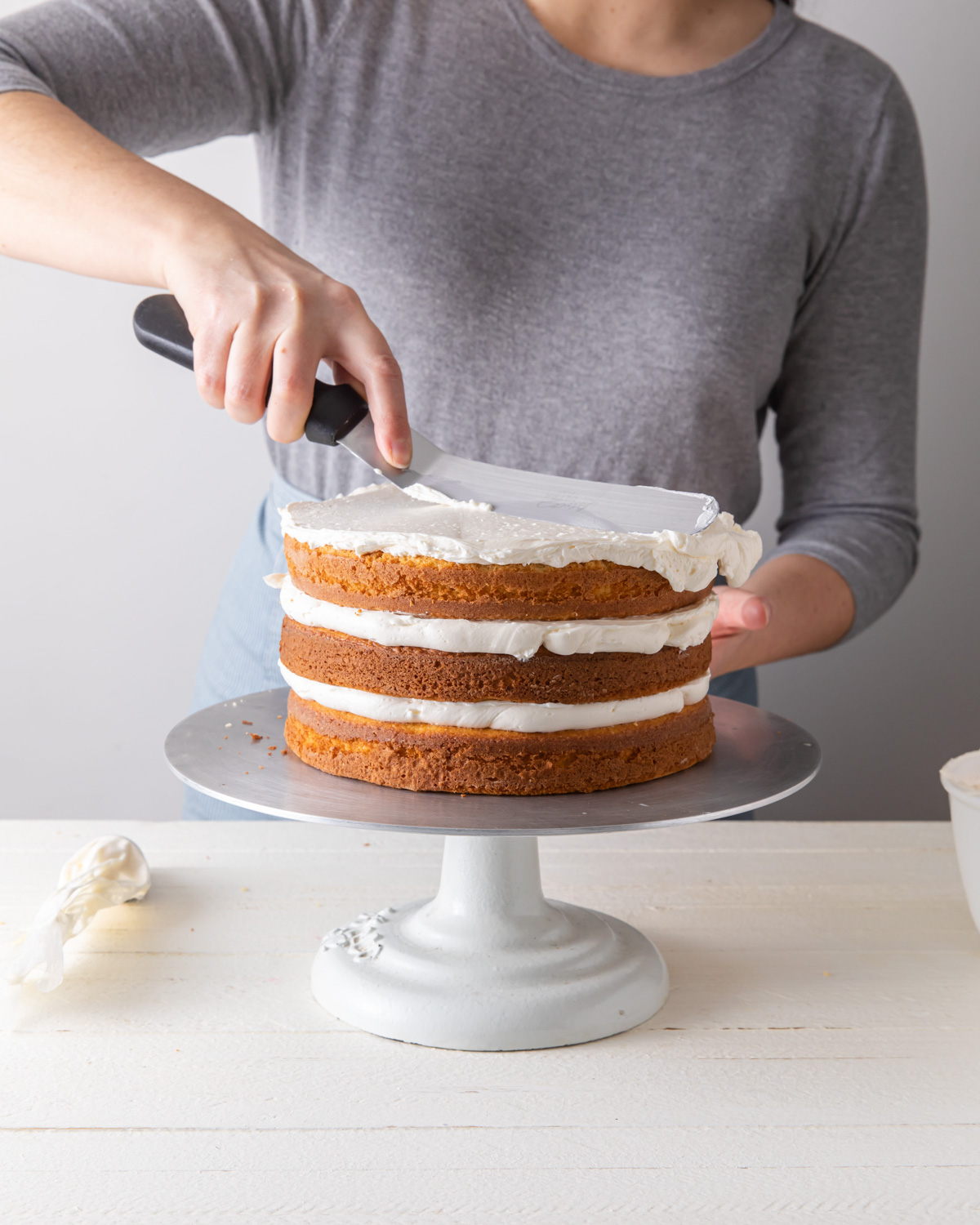 Spread frosting on a layer cake