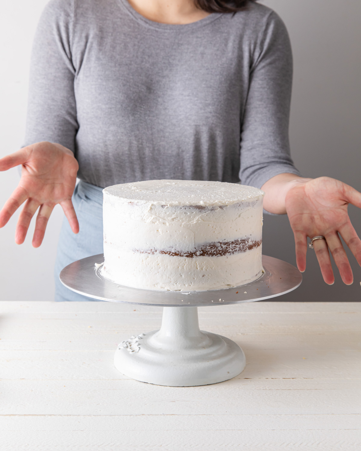 A buttercream crumb coat on a cake