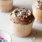 Angel food cupcakes with milk chocolate frosting and sprinkles