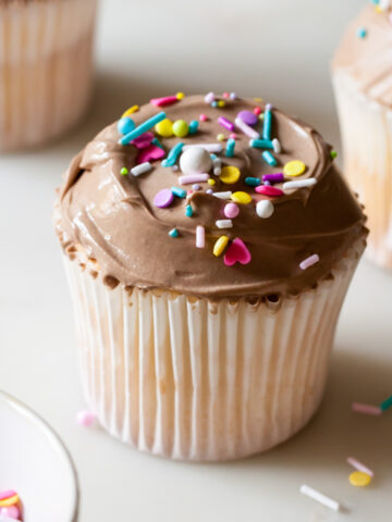 Angel food cupcakes with milk chocolate frosting and sprinkles