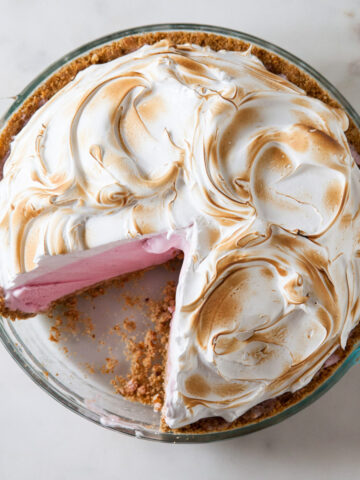 Baked Alaska Ice cream pie with strawberry ice cream and torched meringue on top