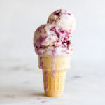 Blackberry swirl ice cream in a cone