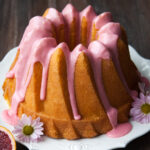A buttermilk bundt cake with pink blood orange glaze on top