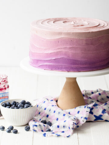 A blueberry layer cake with purple ombre frosting