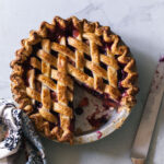 A baked blueberry peach pie with a lattice crust